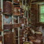 Destroyed from time to time storage room with stored old rusty round boxes with old film